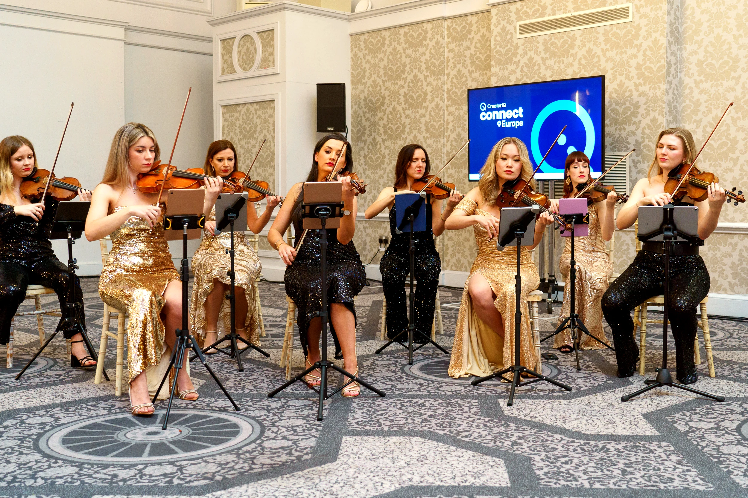 Pop string orchestra violinists performing at a London corporate event